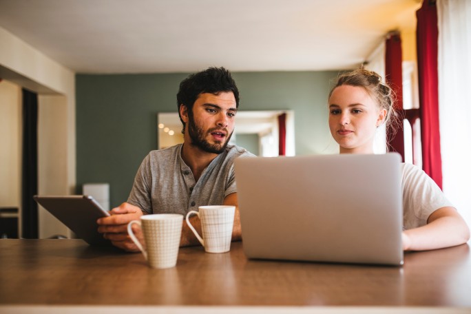 Mladi par proučava bezbednosne savete na laptopu kako bi zaštitio svoje lozinke i lične podatke tokom surfovanja internetom