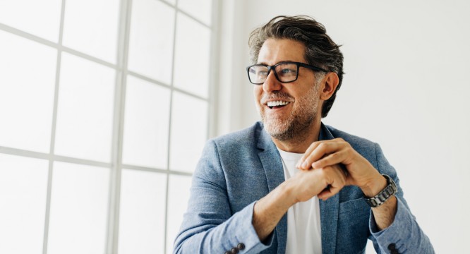 Man in his home after he just opened new Entrepreneur package for his account